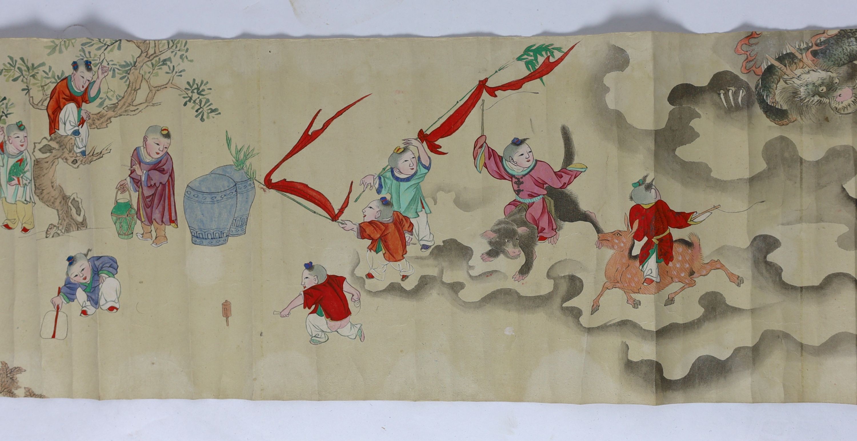 A Chinese handscroll painting on paper of ‘Hundred boys’ in a garden, late Qing dynasty, image 570cm x 26cm